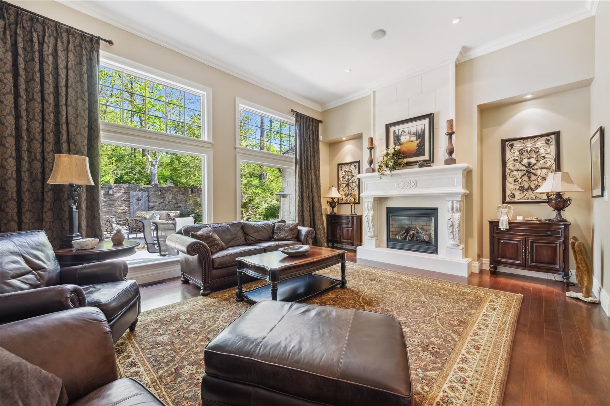 Grand living room with soaring ceilings and forest views